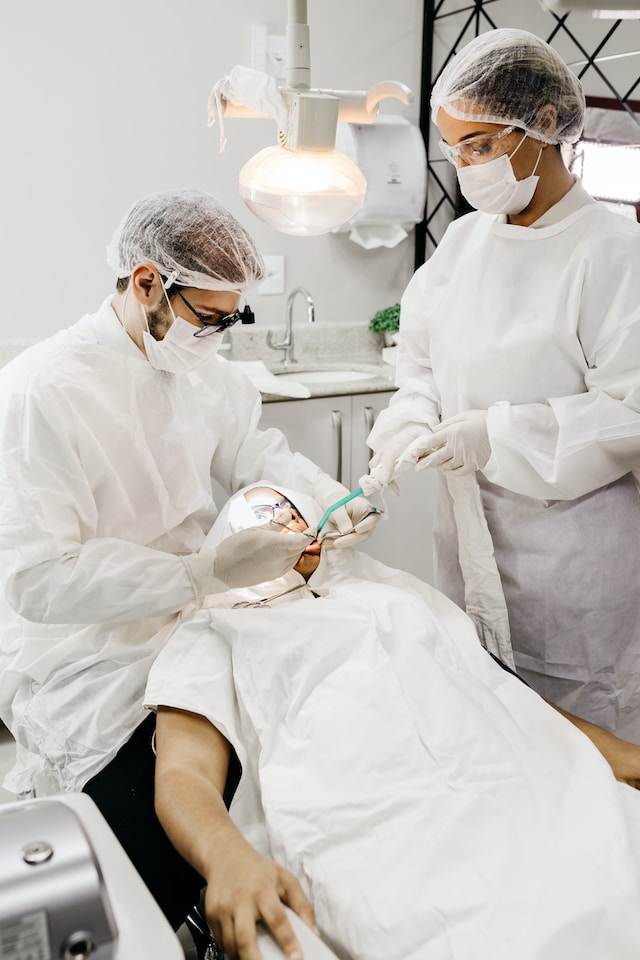 Dentist working with a patient and dental hygienist